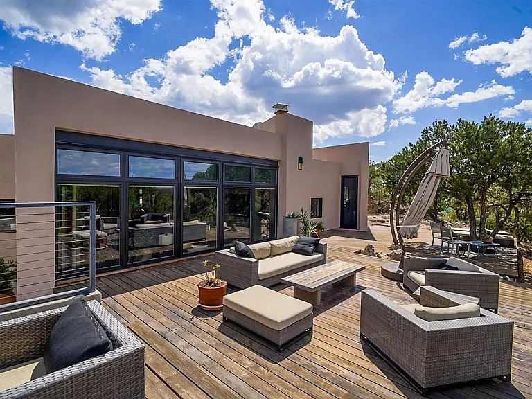 Deck on north side of house, comfy outdoor furniture, large umbrella awning