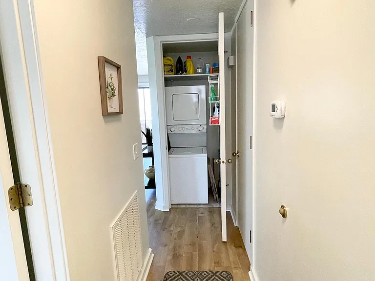 Laundry closet with stacked washer and dryer.