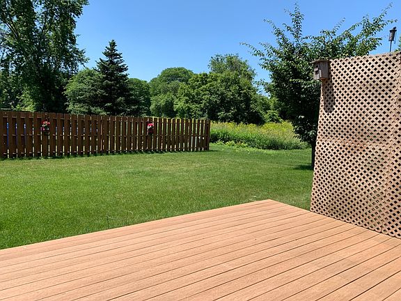 Backyard deck overlooking privacy fence and peaceful green space