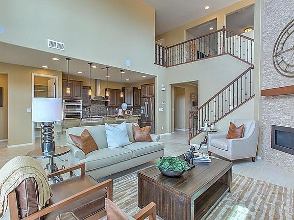 Lovely gathering room interior showing the cathedral ceiling, designer stair railing and a beautiful