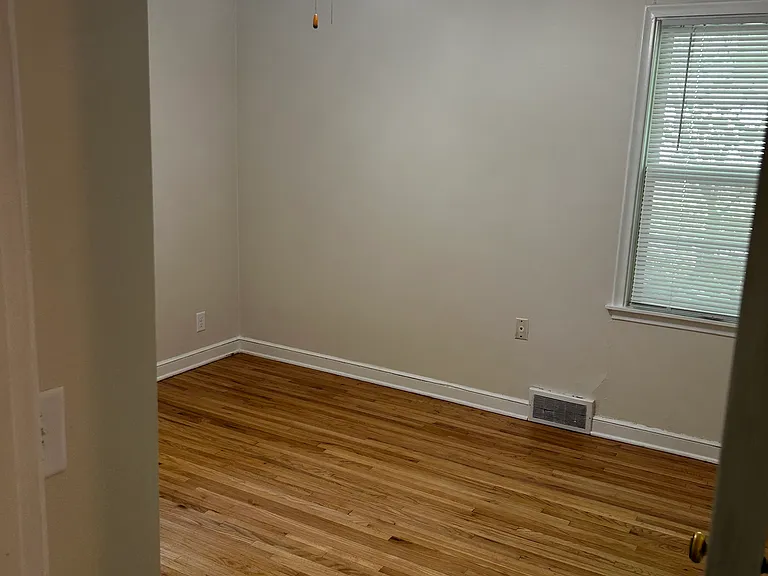 Bedrooms have wooden floors, new window blinds, and ceiling fans.