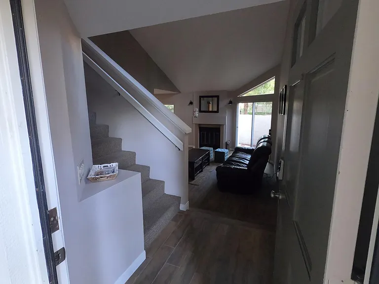 Entryway, stairs, and living room.