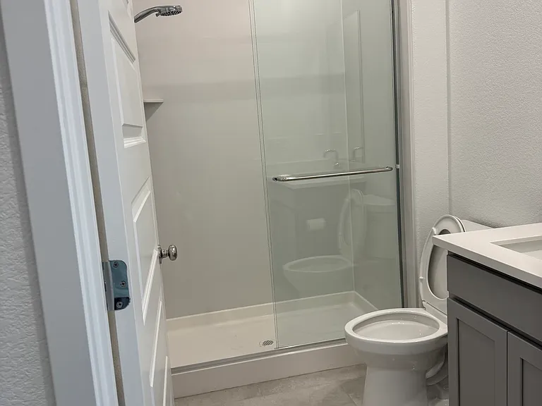 Bathroom with walk-in shower and upgraded shower head.