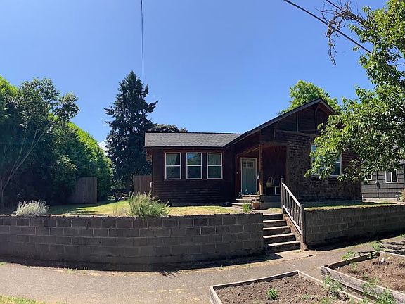 Street view of the bungalow with two raised beds available for whatever!