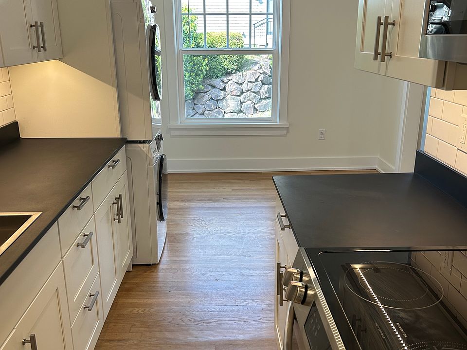 Modern Kitchen with Dining Area that Looks Out Over a Large Window