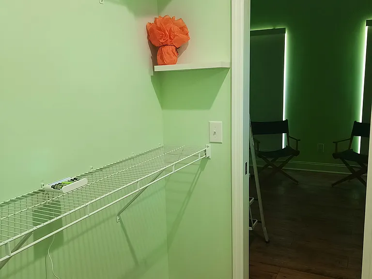 Walk in closet looking toward Master bedroom (black out roller curtains).