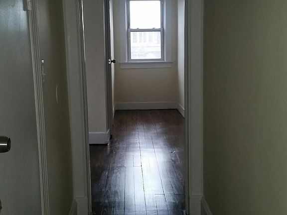 hallway with bathroom & closets on left