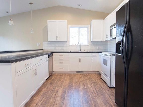 Hardwood flooring in kitchen, dining and living room