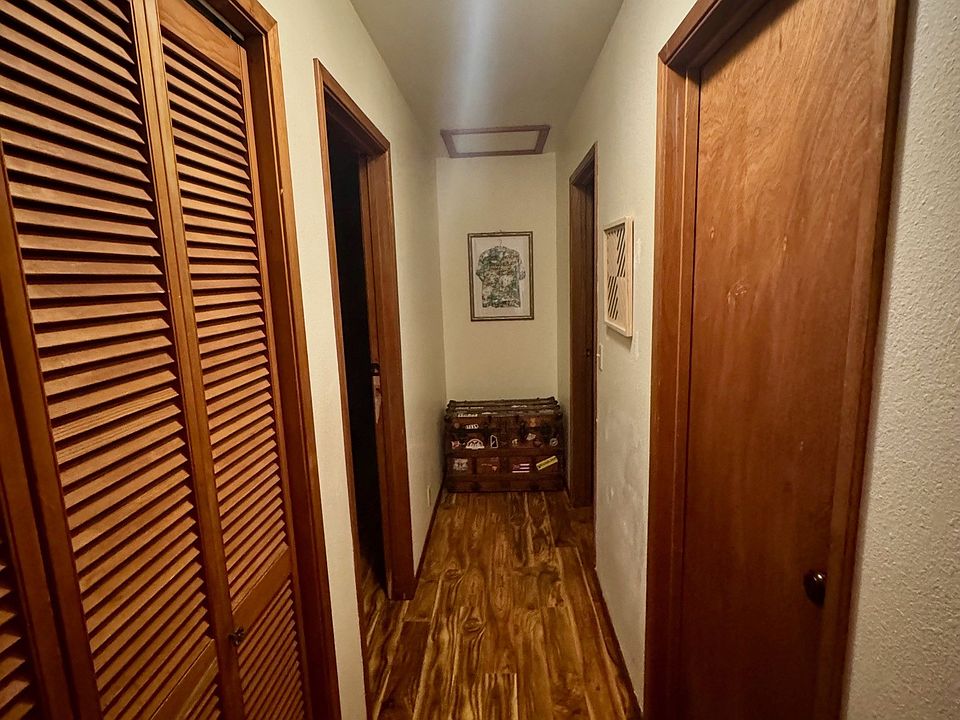 The hallway closet with plenty of shelves for linens and household supplies...and looking towards the doors of both bedrooms.