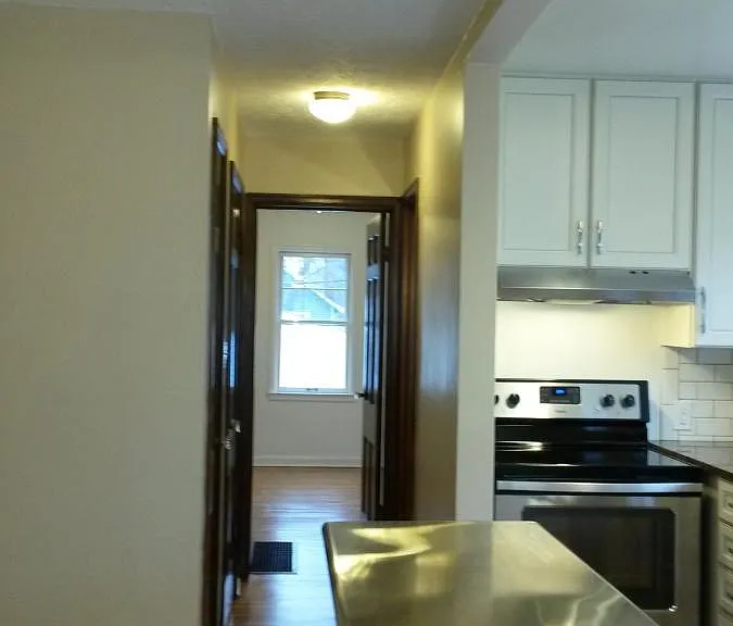 Kitchen and hall view facing towards bedroom