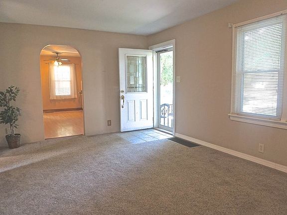 Living room with New carpet & arched doorway