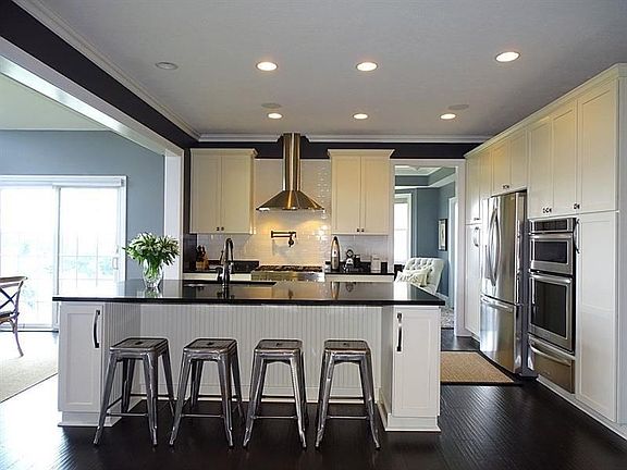 With custom designed maple cabinetry, quality stainless appliances, quartz countertops & a functional center-island, the kitchen