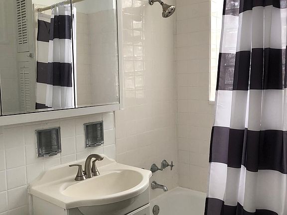 Sparkling all white bath , great light with glass block window.