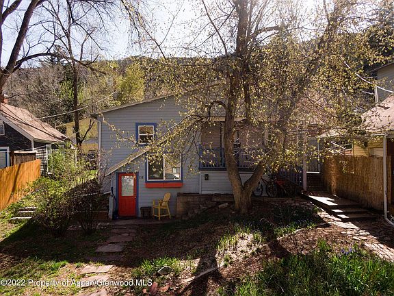 Studio is lower level with Red door.