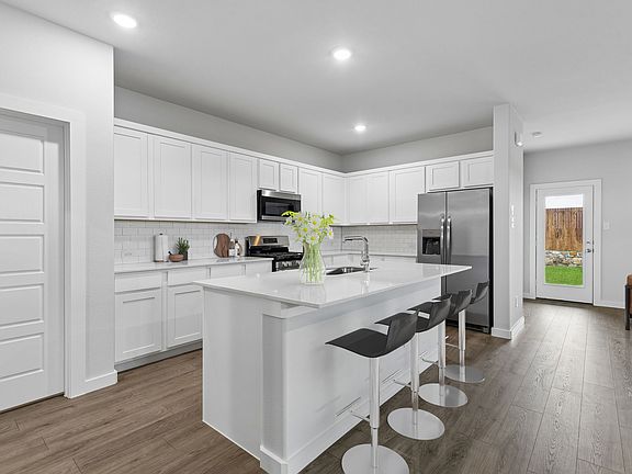 Kitchen in the Oscar home plan by Trophy Signature Homes - REPRESENTATIVE PHOTO