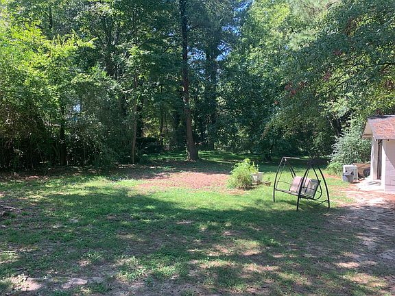 1 car cinder block garage on right 8' fence along the back side of this large lot