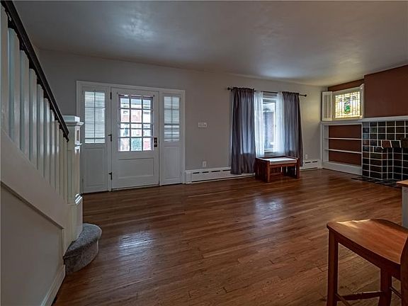 Enter into the generously sized family room with original hardwood floors, bright picture window and fireplace. The main level f