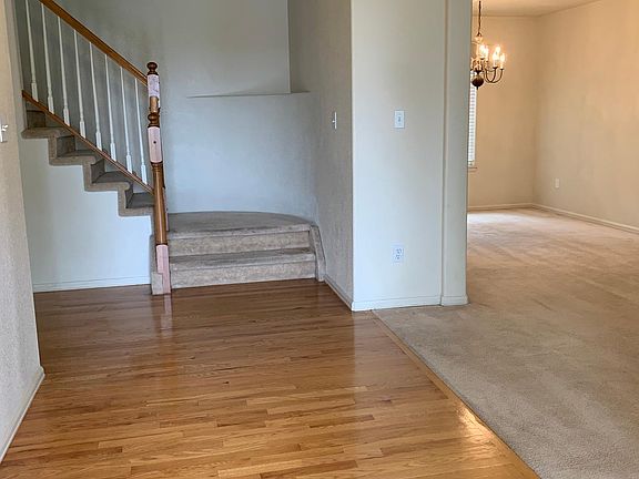 Main Level Entry with Hardwood Floor, into Living Room, Dining Room, Stairs to upper Level