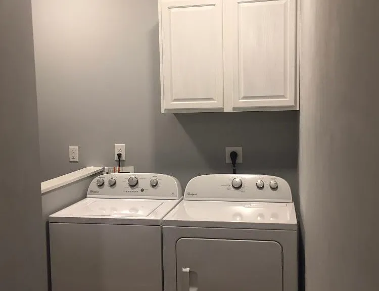 Laundry with door to backyard.
