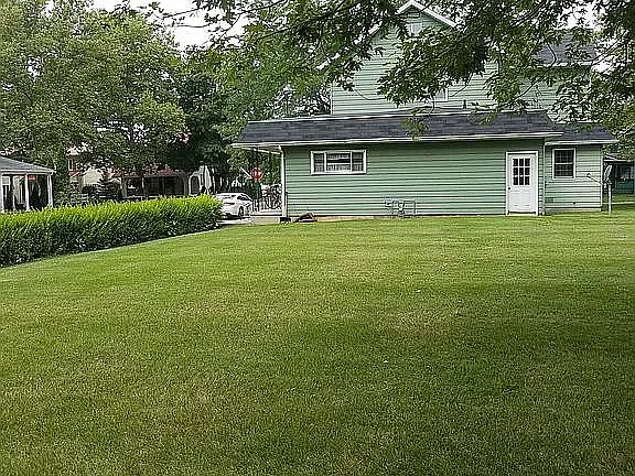 Kitchen window overlooks large backyard. Parking right outside your front door is available.