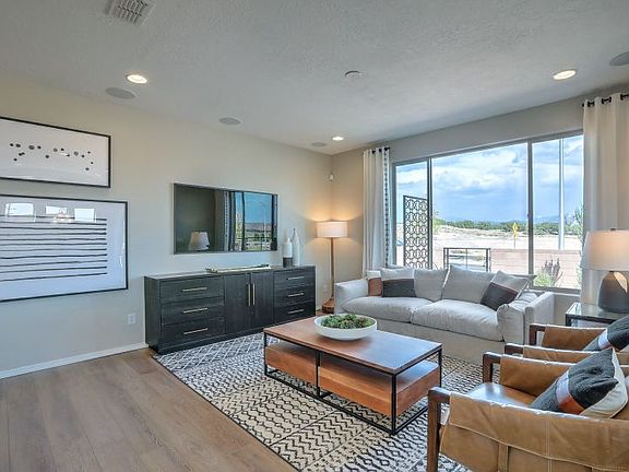 Gathering room offers space for ample seating, a bright window and overhead lighting.