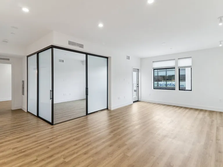 Living room and guest bed with frosted luxury stacked sliding doors