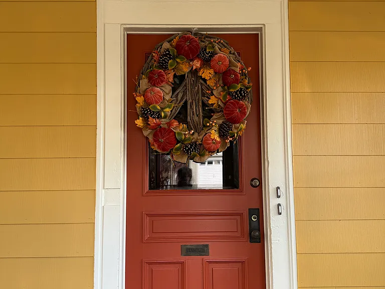 This front door entry door is located inside the front porch. It leads to the inside hallway. That hallway leads to the private entrances per each apartment.