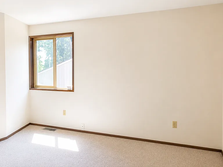 Third bedroom featuring a large closet and a window overlooking the courtyard