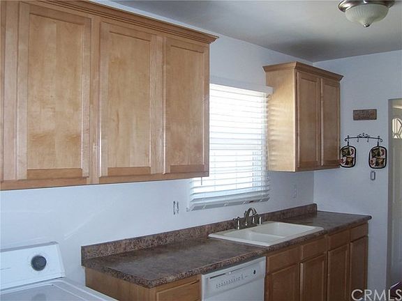 Upgraded eat-in kitchen with plenty of cabinet space and room for full sized washer and dryer.