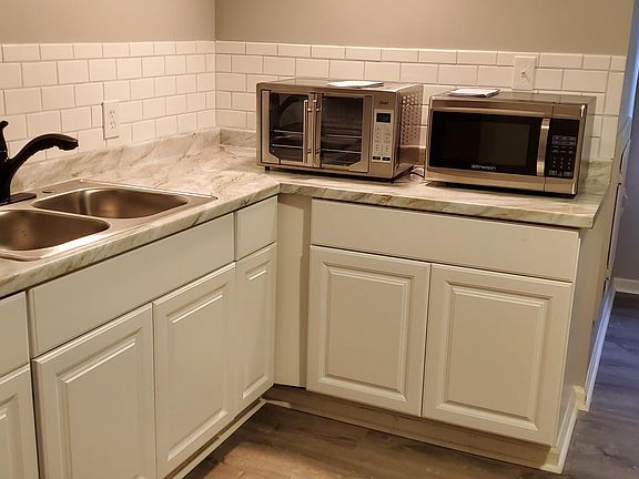 Sink includes garbage disposal and spray nozzle.