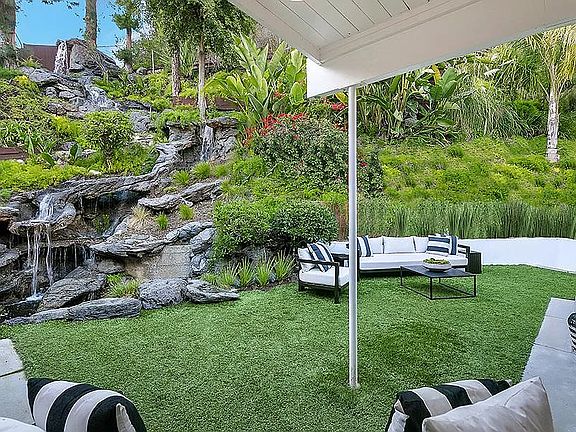 1 of 3 parts to the backyard, with 50 ft. rock waterfall and pond. 2 bedrooms open out to.