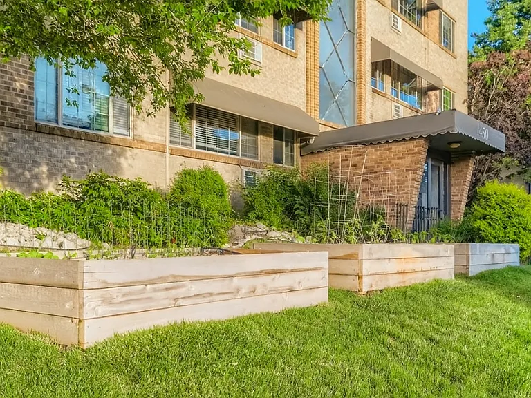 Beautiful raised garden beds out front add a touch of greenery and charm