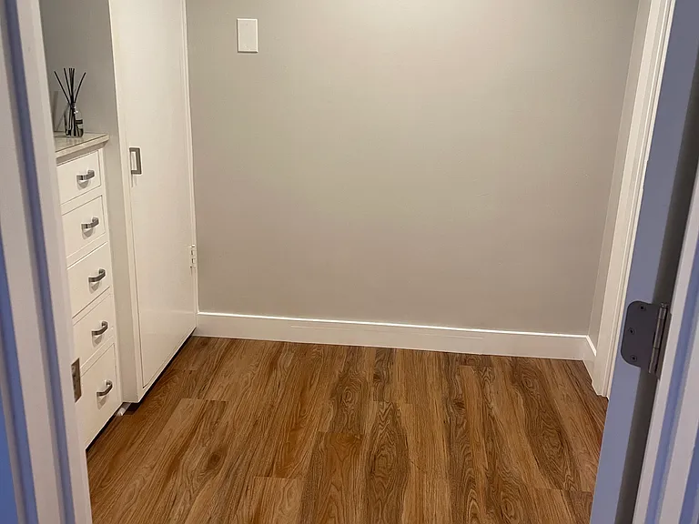 Walk-in closet. There is a spacious clothes hanging closet on the right with built in storage cabinets on left. The photo was taken from bathroom looking into closet. There is another spacious closet in the bedroom if extra storage is needed.