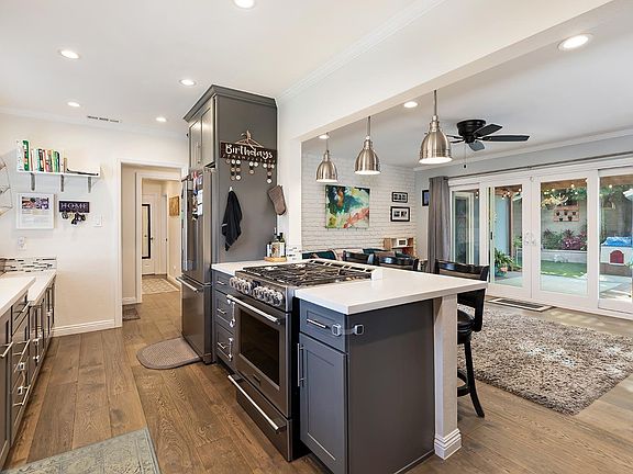 Open kitchen layout with high level appliances.