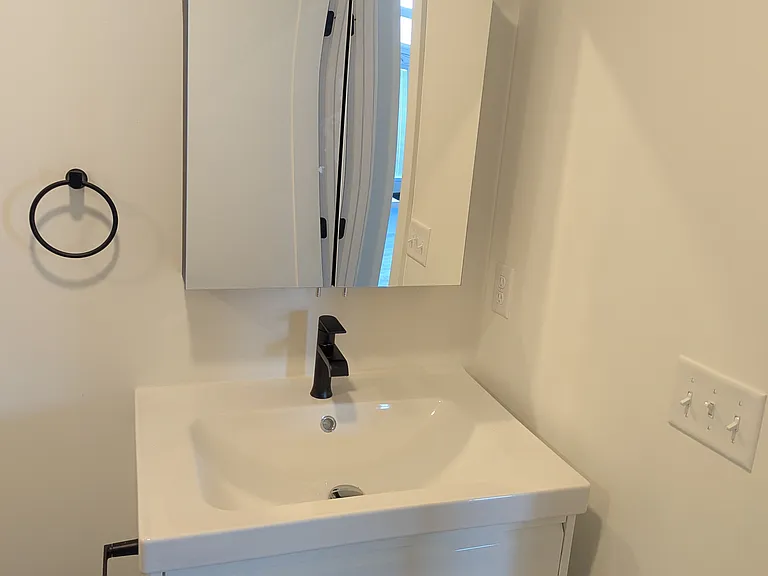 Vanity with mirrored medicine cabinet and Edison lighting