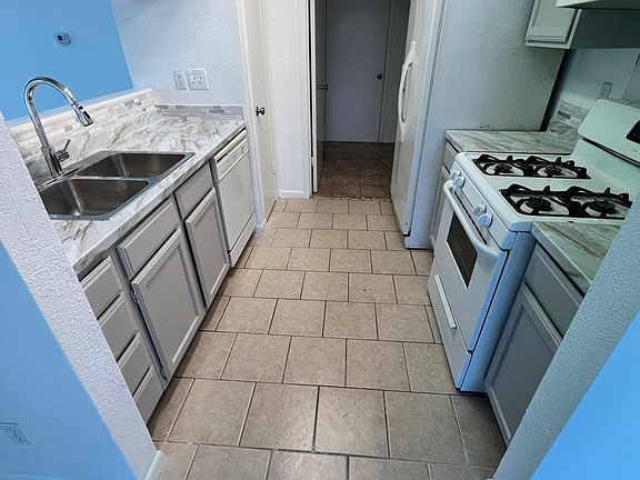 The kitchen that leads to washroom and downstairs restroom