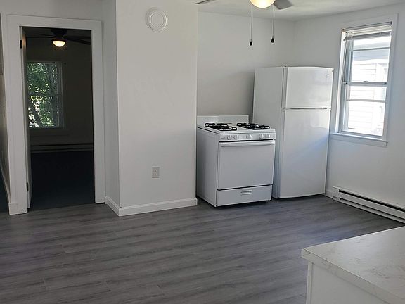 Large Kitchen with fridge and cooker.