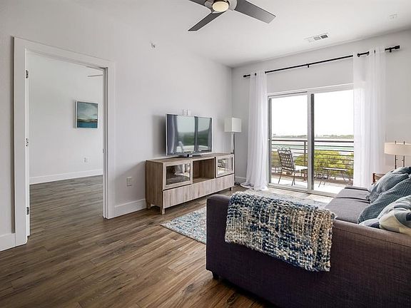 Living room, patio view and view into 2nd bedroom