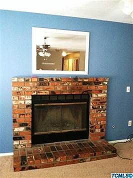 Gas brick fireplace with hearth.
