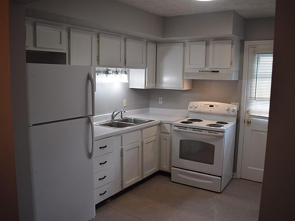 Kitchen with side door entrance to side porch and driveway.