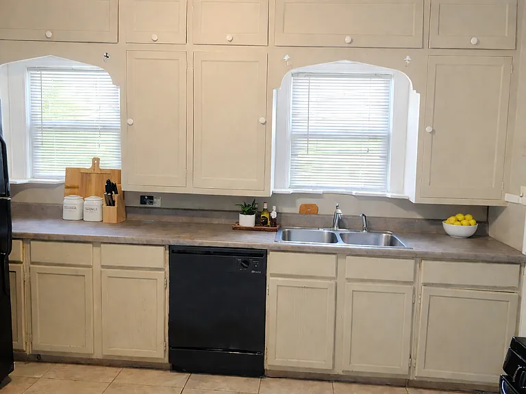 Kitchen has lots of cabinets and counter space. Has refrigerator, gas stove, dishwasher and disposal