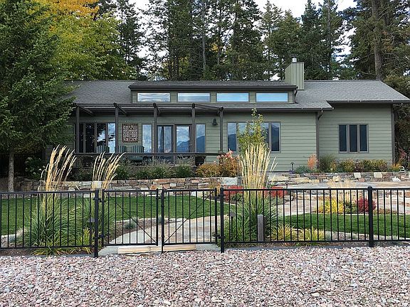 House & fenced lakeside yard