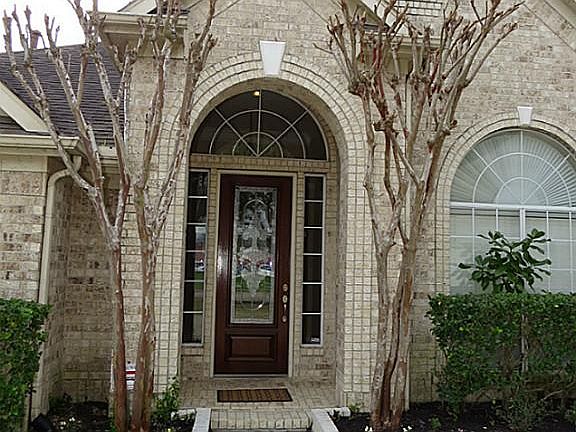 Elegatn Front Entry with Arched Front Porch and Windows. All Sides Brick Exterior.