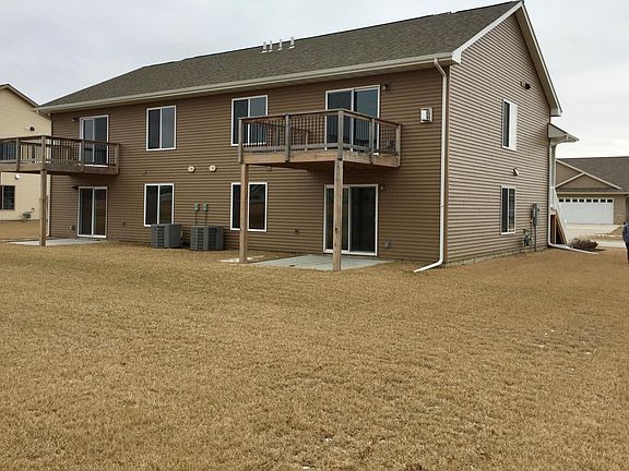 Rear of property with upper deck and lower patio
