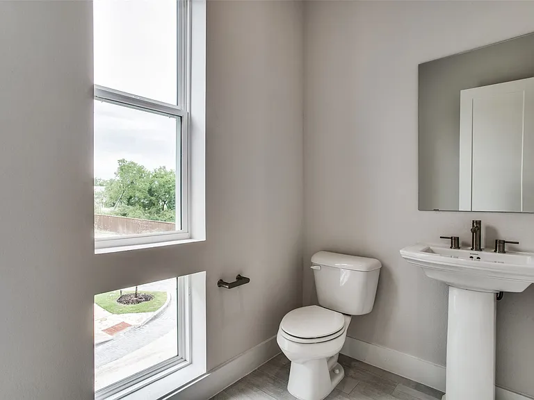 Half Bath conveniently located on the second floor has blinds (not shown).