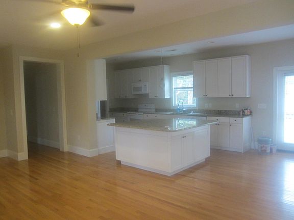 open floor plan with large island with granite counter top