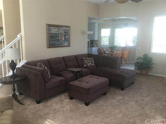 Living room looking into the nook/kitchen with detailed ceiling