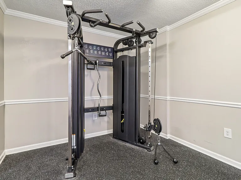 Build strength in our fitness center featuring squat rack, weight bench, and complete training equipment, professionally operated by Highlands Vista Group.