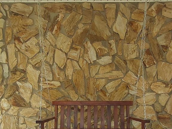 Solid wood double seater hanging swing located on front porch. Exclusive use for 2nd floor guests/tenants.