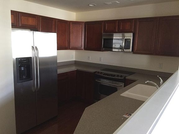 Modern kitchen with stainless steel appliances and recess li